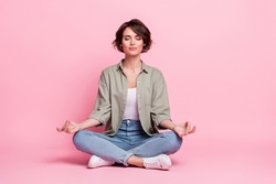 Full body photo of pretty focused lady sit lotus position meditate mudra fingers isolated over pastel color background