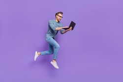 Photo of excited bust guy wear grey shirt spectacles jumping high typing modern device isolated violet color background