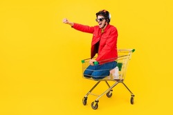 Full length body size view of attractive cheery guy inside cart having fun riding fooling isolated on bright yellow color background