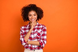 Photo of young curly lady hand face wear plaid shirt isolated on orange color background