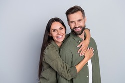 Portrait of attractive cheerful amorous couple best friends hugging romance spending time isolated over grey pastel color background