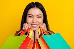 Photo of cool young brunette lady do shopping isolated on yellow color background