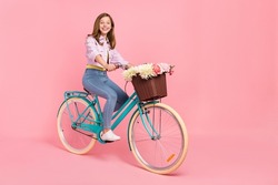 Photo of positive carefree lady drive bicycle toothy beaming smile wear jacket isolated pink color background