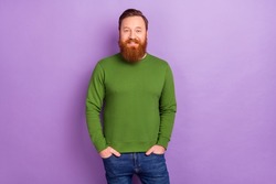 Photo of attractive foxy male holding hands in pockets posing on camera wear green pullover isolated on violet color background