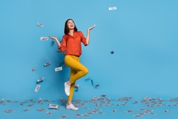 Full size photo of young cheerful girl rich earnings lottery money credit look empty space isolated over blue color background