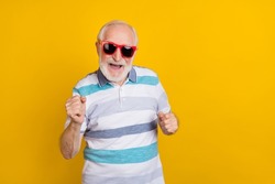 Portrait of attractive cheerful grey haired man fooling having fun dancing isolated over bright yellow color background