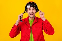 Photo of impressed young brunet guy wear helmet jacket isolated on yellow background