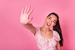 Portrait of pretty excited girl arm palm give high five toothy smile isolated on pink color background