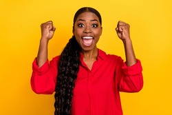 Photo of young excited girl rejoice luck ecstatic lottery fists hands triumph isolated over yellow color background