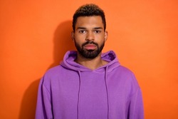 Portrait of attractive bearded man wear casual clothes purple pullover look camera isolated on orange color background