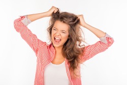 Portrait of crazy funny girl shouting and holding hair