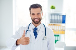 Close up portrait of smiling doctor recommending the new way of treatment by showing thumb up