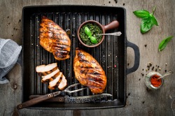 Chicken fillet in the grill pan. Grilled meat with pesto sauce