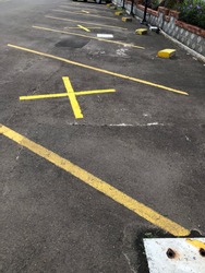 Cross sign of social distancing in parking lot to avoid virus spreading