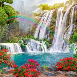 
Beautiful view of the lake and waterfall. Flowers by the lake