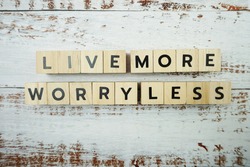 Live More Worry Less Word alphabet letters on wooden background