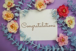 Congratulations typography text and flower decorate on purple background