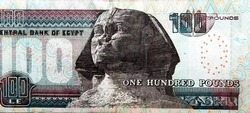 Large fragment of the reverse side of 100 LE one hundred Egyptian pounds bill banknote series 2013 features Sphinx of Giza, selective focus of Egyptian cash money