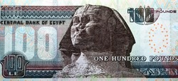 Large fragment of the reverse side of 100 LE one hundred Egyptian pounds banknote series 2017 features the Sphinx of Giza, selective focus of Egypt cash money bill by central bank of Egypt