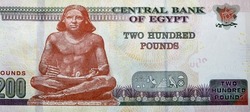 Large fragment of the reverse side of 200 LE EGP two hundred Egyptian pounds cash money banknote paper series 2022 features the seated scribe of ancient Egypt, selective focus of Egyptian money