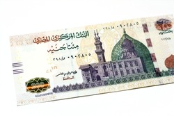 Obverse side of 200 LE EGP two hundred Egyptian pounds cash money banknote series 2022 features the mosque of Qani-Bay in Cairo, Egypt, selective focus of Egyptian money isolated on white background