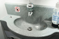 Passanger airplane toilet handwash sink close up
