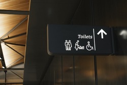 Modern public toilet sign on the wall