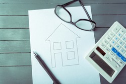 Mortgage or loan concept. A drawing of a house and calculator