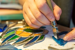 cutting stained glass with a glass cutter, glass scraps, stained glass crafting