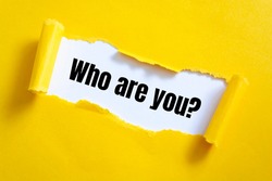 Who are you? question written under torn paper.	