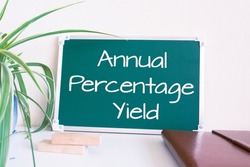 Text Annual Percentage Yield written on the green chalkboard