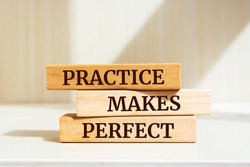 Wooden blocks with words 'Practice Makes Perfect'. Business concept