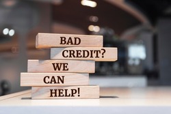 Wooden blocks with words 'Bad Credit Question We Can Help'.
