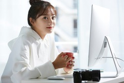 A young Asian woman working in the creative industry