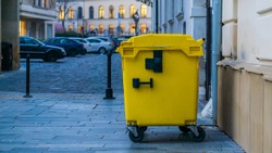 yellow container for salary waste at night on the street in Bratislava