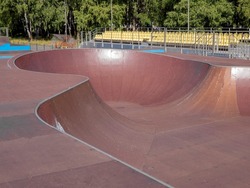 Curved walls of skate bowl. Bowl park for skaters, rollers, scooters. Sport ground, selective focus