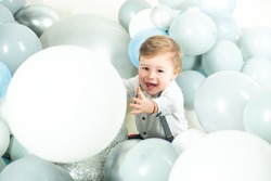 Funny boy. Beautiful smiling child with ballons. Celebrating birstday b-day. Enjoying the moment. Emotions on the face. Adorable baby having fun. Happy moments. Copy space