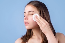 Woman with cotton pads, sponge, cotton ball. Skin care and beauty concept. Girl removes makeup with cotton ball from face. Skin care concept. Woman using cotton pad.