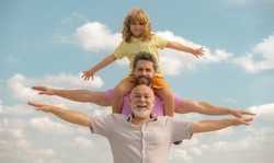 Father, son and grandfather happy multi genration family with aising hands or open arms flying on sky. Generations men.