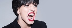 Woman shouting and screaming loud with open mouth. Horizontal banner for website design. Web banner header, copy space. Close up screaming face.