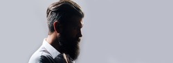 Closeup profile silhouette of bearded man with classic black long beard, bearded gay. Barber barbershop. Mustache men, serious face close up. Templates web banner design. Banner for website.