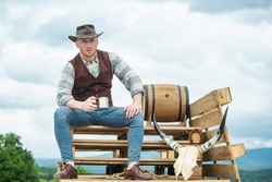 Farmer cowboy hold cup coffee or tea. Western life. American country male portrait. Farm owner worker in countryside on farm or ranch.