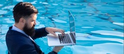 Businessman in suit with laptop on swimming pool. Banner for header, copy space. Poster for web design.