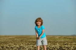 Farm for child. Soil and ground concept. Kids portrait on farmland.