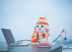 Xmas or christmas decoration, audio book. Happy holiday celebration, new technology. New year snowman in hat. Christmas and education, fairytale. Snowman in winter with laptop, headset and book.
