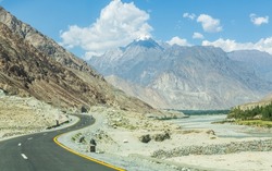 Karakorum highway and Gilgit river, tributary of the Indus river, flowing through the beautiful mountain valley in the Karakorum mountains in Pakistan