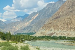 Gilgit river, tributary of the Indus river, flowing through the beautiful mountain valley in the Karakorum mountains in Pakistan