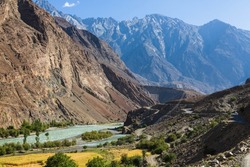 Gilgit river, tributary of the Indus river, flowing through the beautiful mountain valley in the Karakorum mountains and old Karakorum road in Pakistan