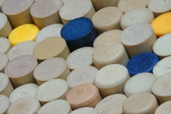 Many clean and logo-free synthetic wine corks are shown standing on display in a diagonal view.