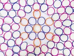 Rubber bands designed for colorful of flower on disc at center point which surround circles shapes on white background.